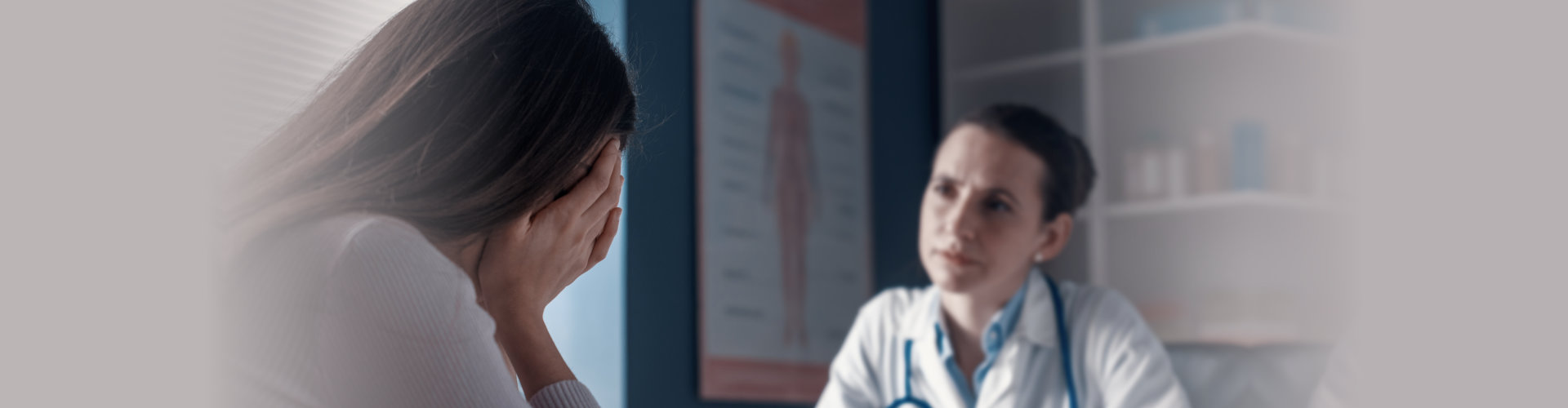 Professional doctor assisting a woman in her office. the patient is crying and feeling hopeless